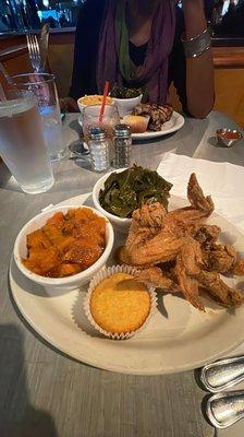 Chicken wings and yams, greens.