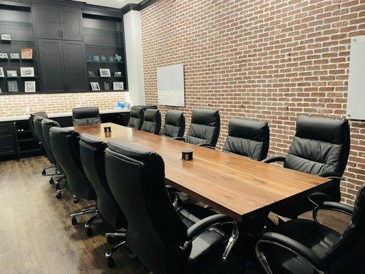 Commercial boardroom redone with custom made cabinets and board room table.