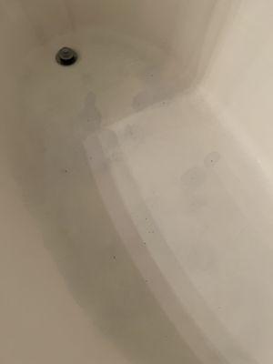 Stained bathtub with holes in it, holes filled by maintenance with silicone. Top notch work?