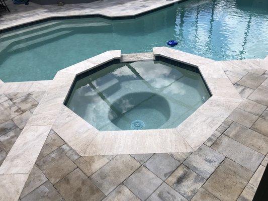 Paver and travertine pool and spa deck with travertine coping