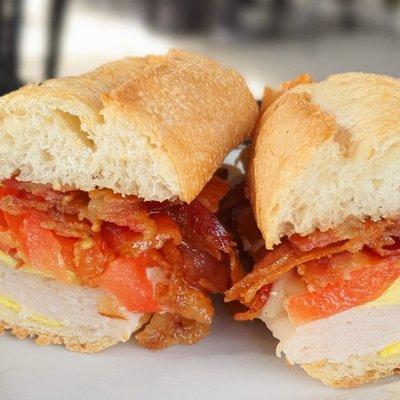 Breakfast sammie loaded with bacon, egg, turkey, and tomato, $10. Perfect to share.