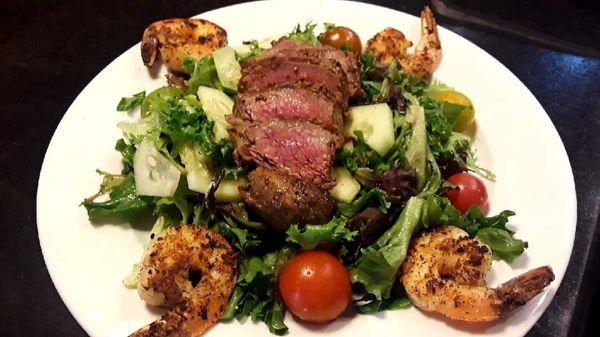 Flat iron steak salad with shrimp and a feta dressing.