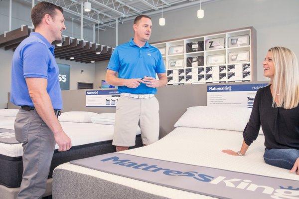 Mattress friendly staff helping customers select a mattress