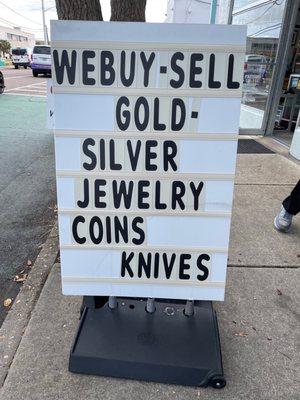 We buy sell gold silver jewelry coins knives sign