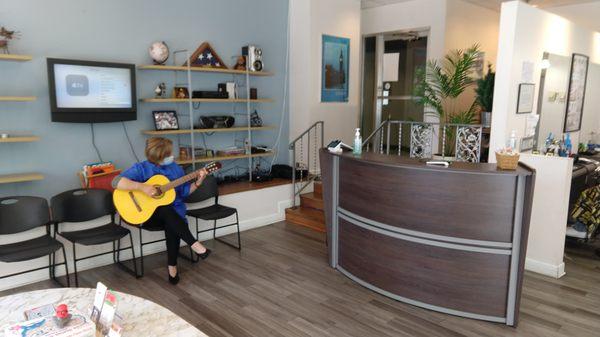 Live classical guitar by one of the barber/stylists