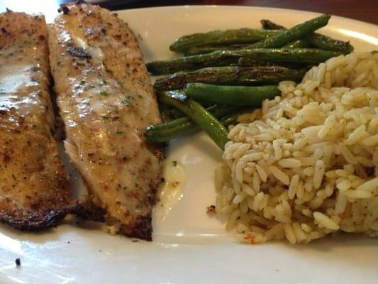 Herb crusted tilapia with sides grilled green beans and rice pilaf