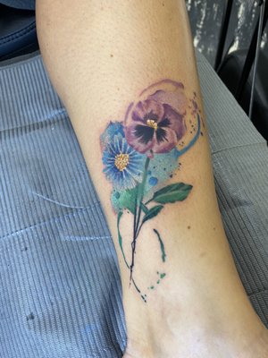 A tattoo for 37 years with my best friend. My birth flower and hers, with the infinity sign.