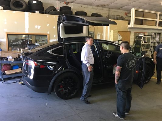 Tesla SUV getting a state inspection sticker.