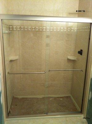 Semi frameless bypass shower with through glass towel bars