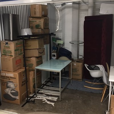 Carefully and neatly stacked boxes and items in storage unit. Easy access both in and out.