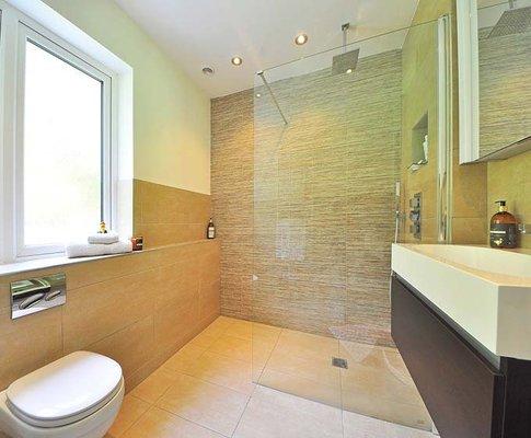 walk in tile shower in bathroom