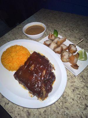 Barbecue pork ribs and Pork crackling with yellow rice and red beans.