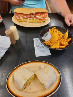 Italian sub, Buffalo finger wrap, and waffle fries.