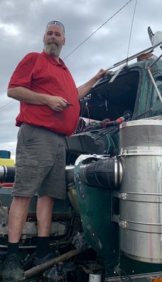 Tod explaining how the frame of the truck had to be clean and green of dirt and debris so the automotive glass adhesive will properly set.