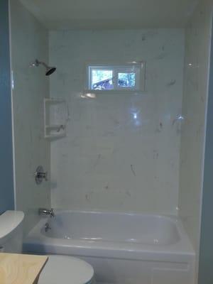 New window and Cultured Marble Tub Shower surround.