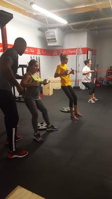 Ladies working their backs with resistance bands