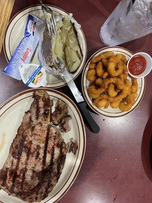 One pound Delmonico ribeye cooked perfectly medium, fried shrimp and a hot baked potato..