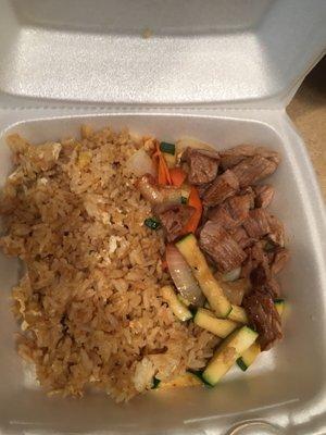 Hibachi steak with vegetables and fried rice.