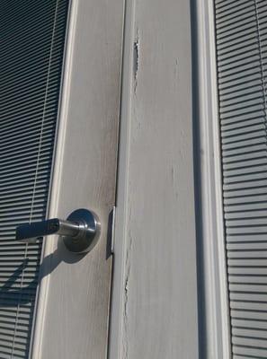 Exterior door, dirty, peeling paint.