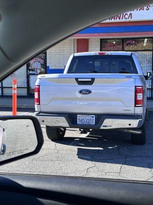 This lady is parked between two parking spots. Maybe the one one that needs to learn and drive and park is  her.