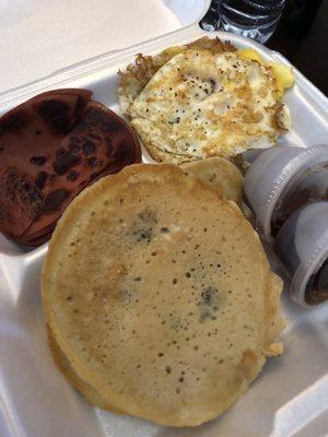 Pancake breakfast platter with blueberries and bologna and eggs