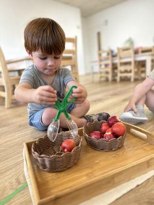 Educational Preschool in Shadowridge, Vista. Practical life activity #concentration, #focus #fine motor skills.