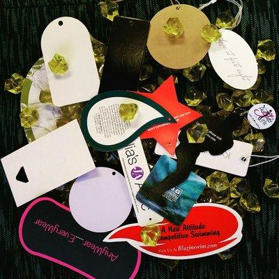 Die cut paper hangtags for garments or accessories.