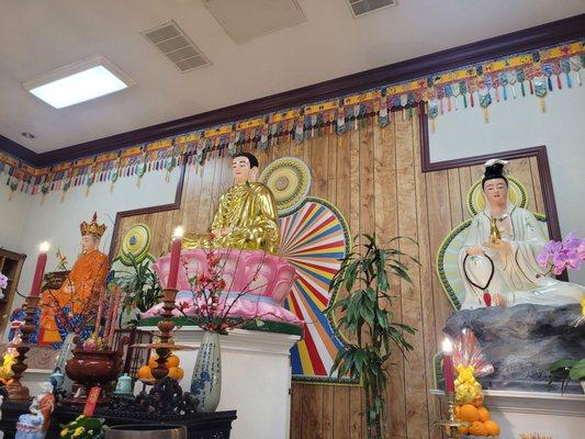 Buddha in the center between Ksitigarbha and Avalokiteshvara