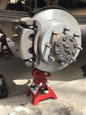 Rear brake pad, rotor, and caliper replacement for 2009 Ford F-250 at customer's home.