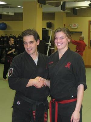 Master Brenner congratulating Ali for passing her pre test for Black Belt