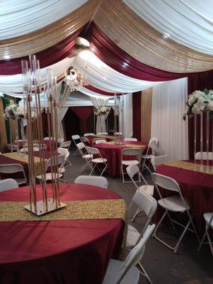 Shed with draping , linens , centerpieces tables and chairs