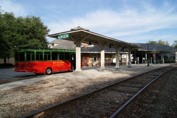 The Aiken Visitors Center and Train Museum with the trolley out front getting ready to depart for a Historic Aiken Trolley Tour.