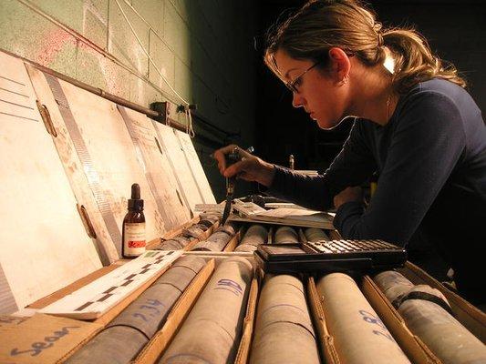 Geologists visually inspect core samples in the company's lab.