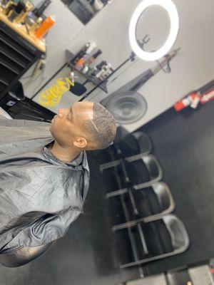 Mid fade with a scissor cut and & razor edge up