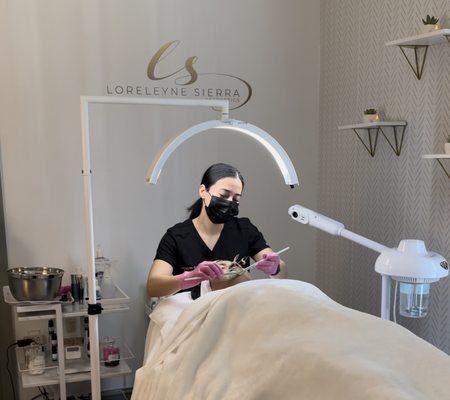 Loreleyne performing a customized facial treatment.