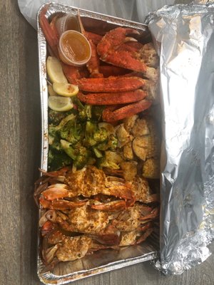 Snow crab legs and blue claw crabs sautéed with veggies