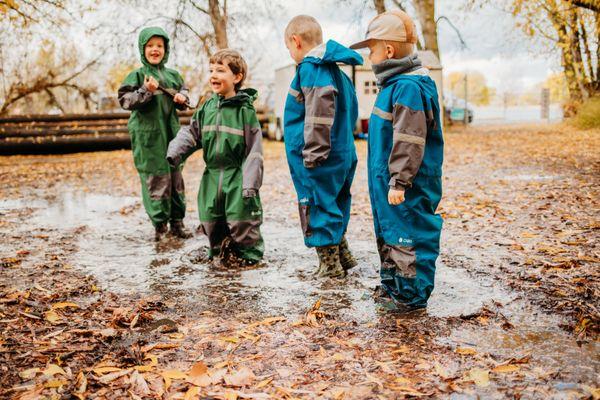 Forest Preschool playing in our Oaki suits after a rain fall