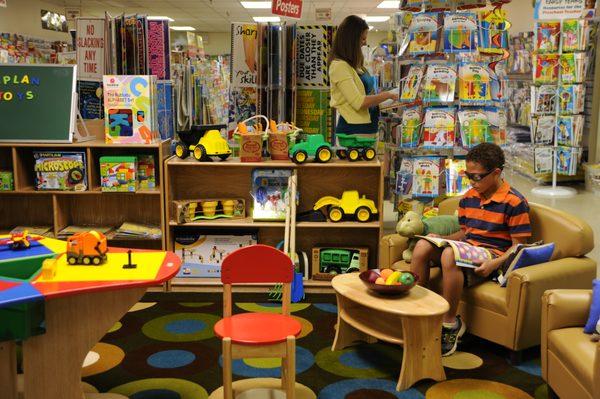 One of our smaller customers is looking through an activity book, while another customer continues to browse.