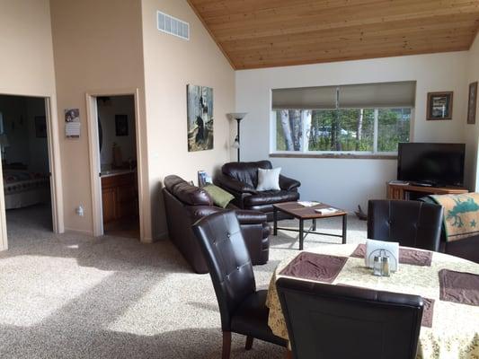 The cottage main room has an open concept plan that includes the kitchen, dining area, and den.