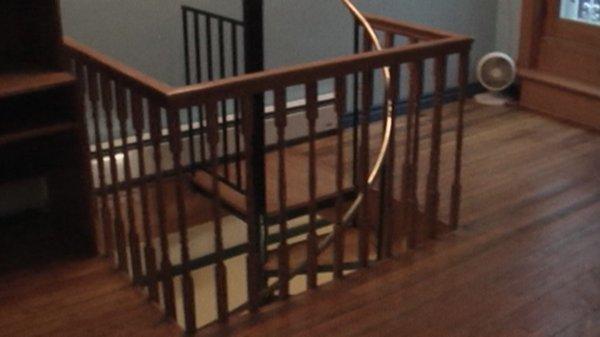 Circular stairway installation with oak spindle railing