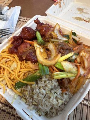 Half chowmein and fried rice with orange chicken and Beijing beef.