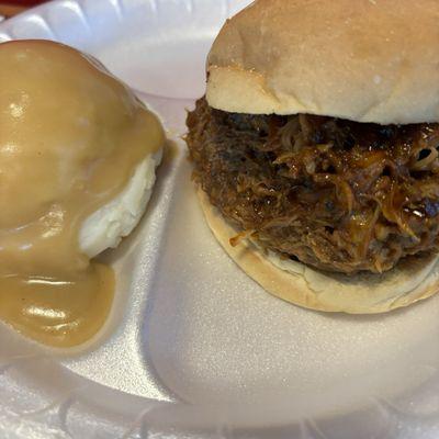 BBQ Pork on a Kaiser Roll Sandwich with mashed potatoes