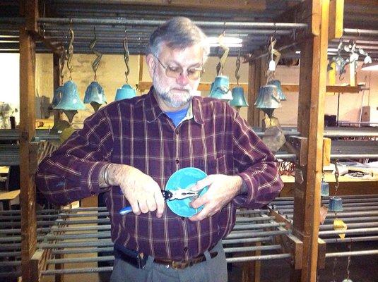 Bradley Cross, assembling a Bronze Windbell.