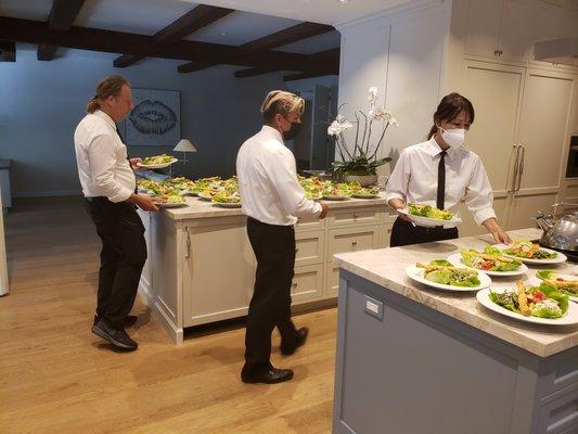 Our staff serving the salads at a Private  home party catered by Michal Harris Cuisine