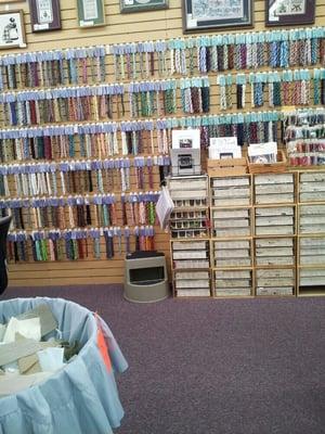 Embroidery floss and cross-stitch/needlepoint supplies.