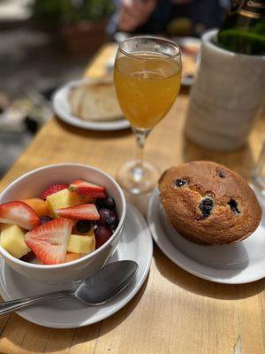 Yogurt with Fresh Fruit and Granola (minus granola) Peach Bellini and blueberry muffin