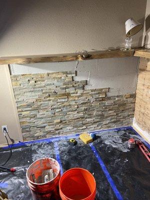 Stacked stone, getting installed behind the new fireplace