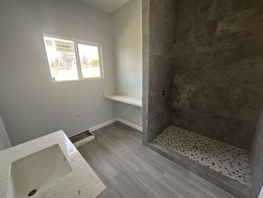 Bathroom floor, shower and vanity.