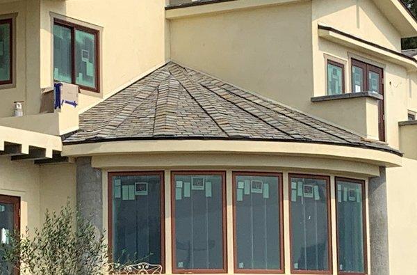 5:12 pitch quarter circle slate roof over vaulted living room.