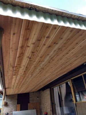 Cedar tongue and grove outdoor patio cover ceiling.